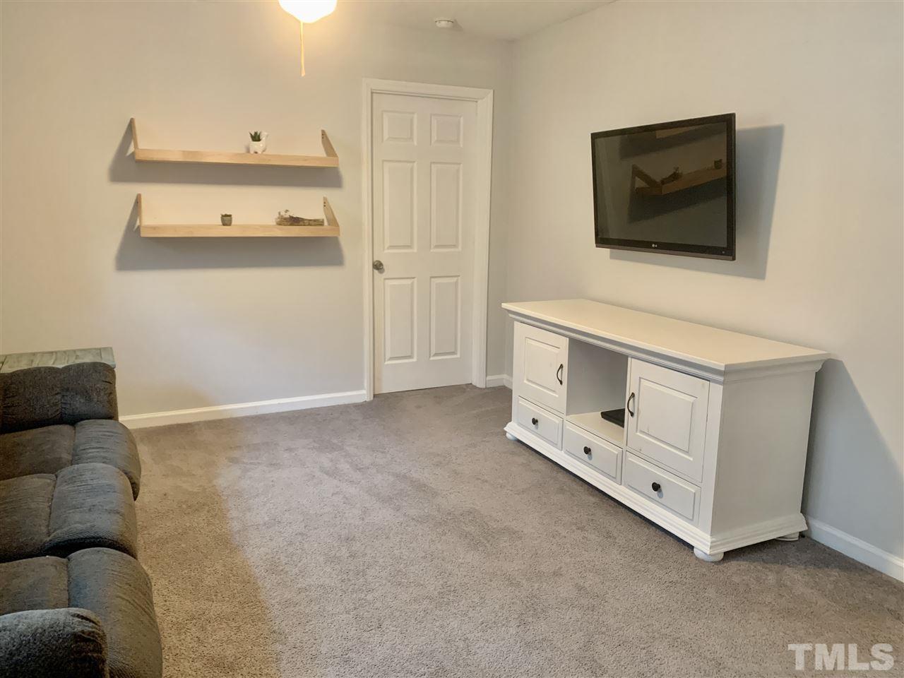 816 Patrick Road Bahama, NC 27503 - Photo 13 of 20 a living room with furniture and a flat screen tv