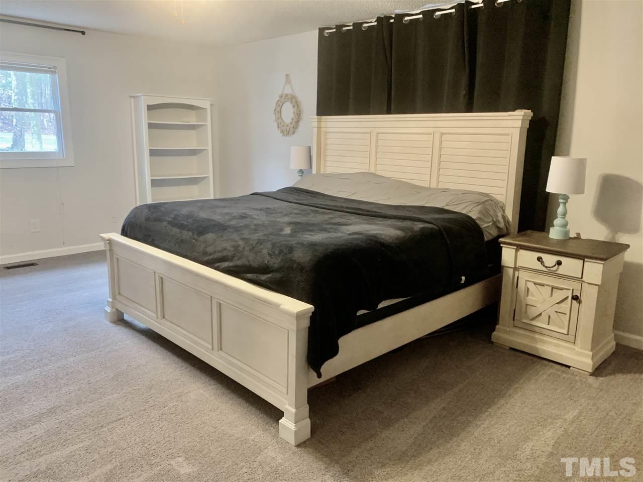 816 Patrick Road Bahama, NC 27503 - Photo 15 of 20 a bedroom with a bed and a cabinets