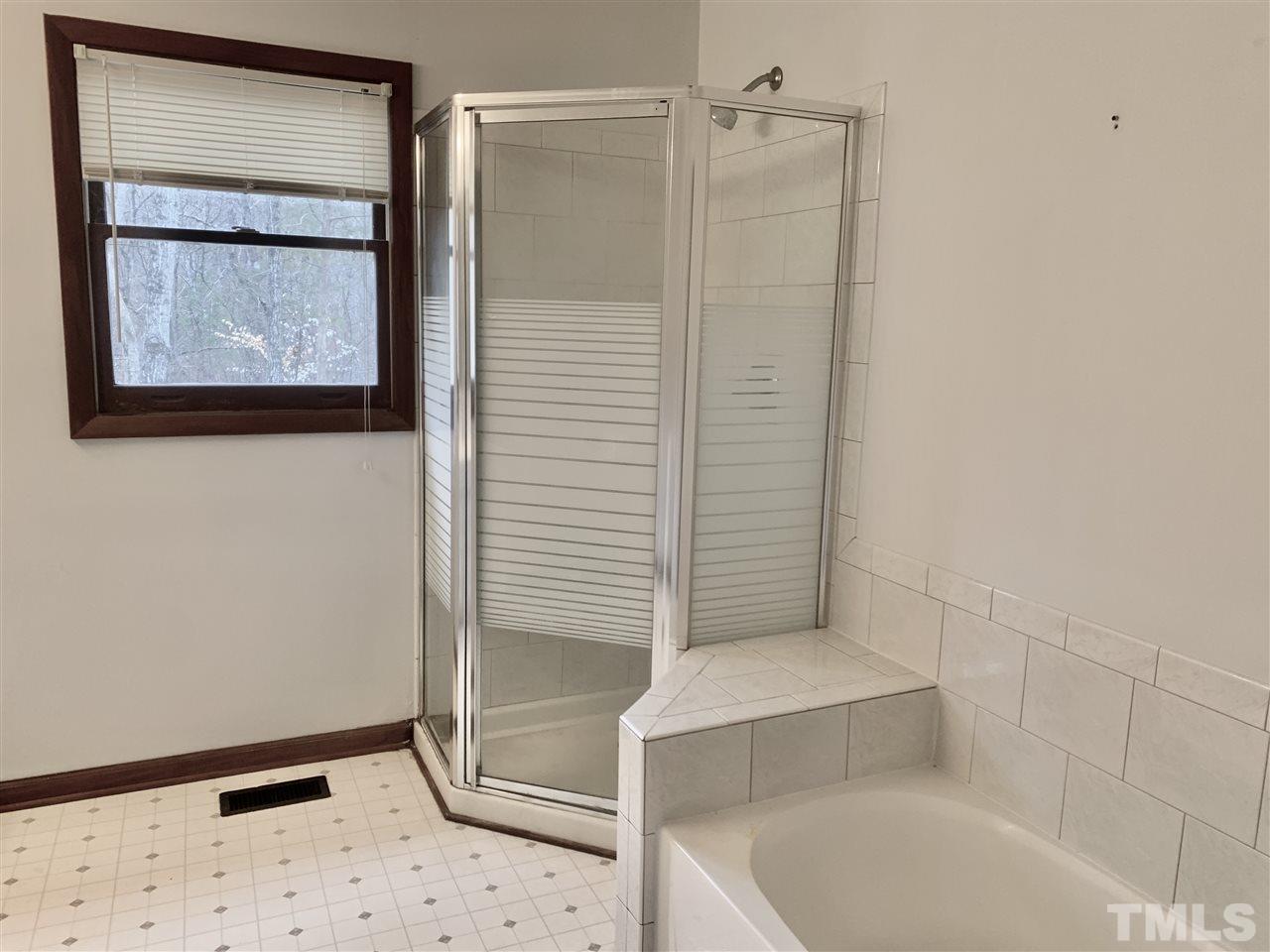 816 Patrick Road Bahama, NC 27503 - Photo 17 of 20 a bathroom with a tub and shower