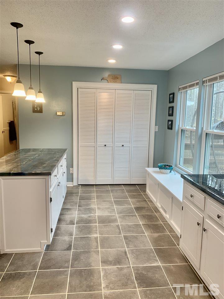 816 Patrick Road Bahama, NC 27503 - Photo 8 of 20 a spacious bathroom with a granite countertop tub a sink and a glass door shower