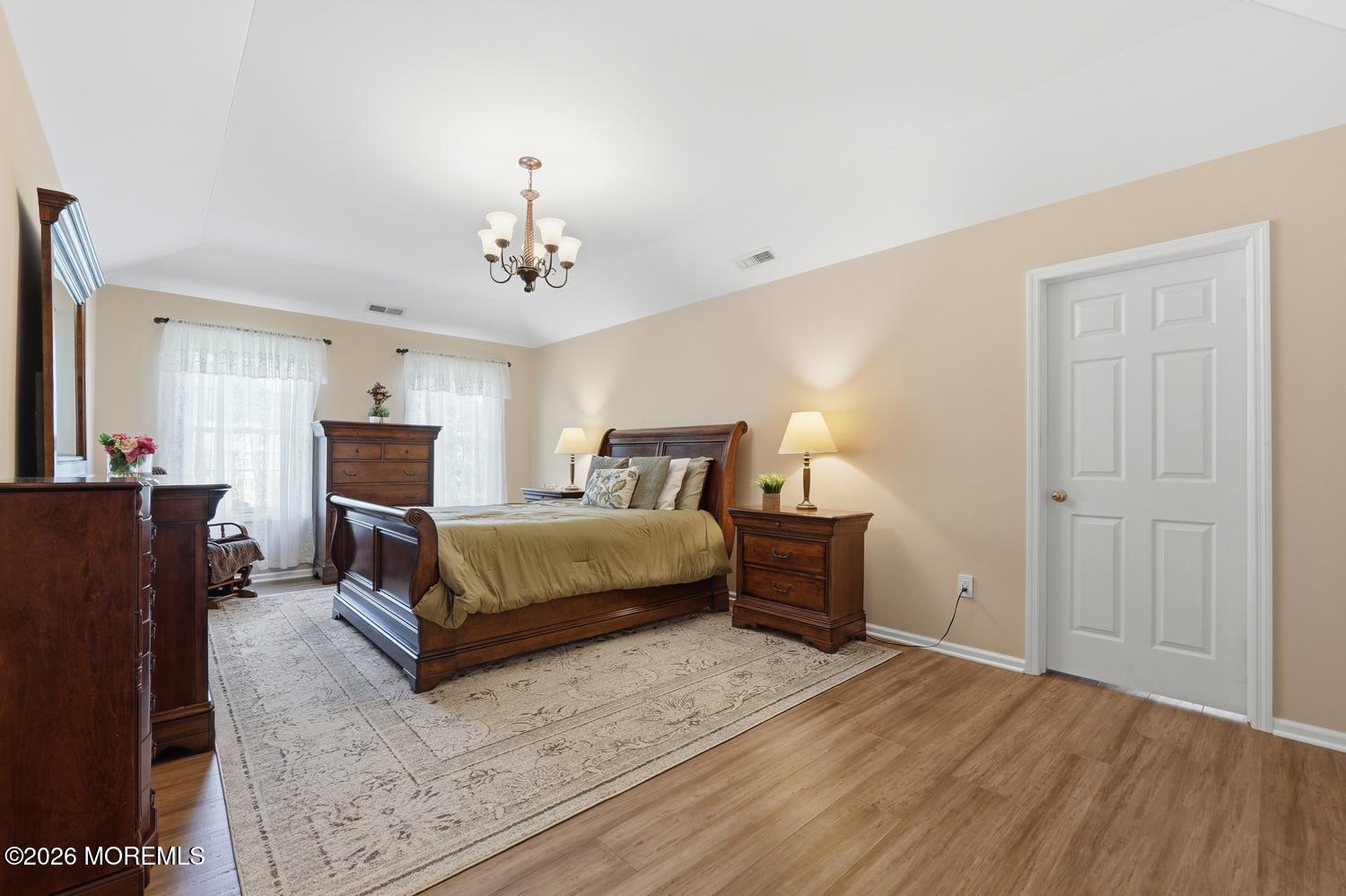 7 Cherry Tree Lane Cream Ridge, NJ 08514 - Photo 18 of 47 a spacious bedroom with a bed and a chandelier