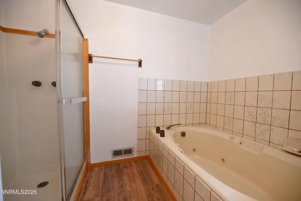 a bathroom with a bathtub and shower