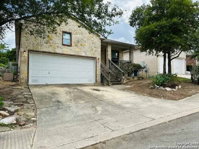 a view of a tree in front of a house
