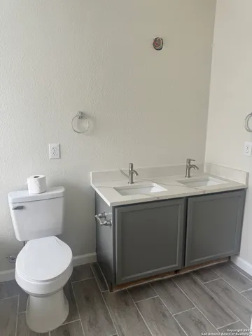 a bathroom with a sink vanity and toilet