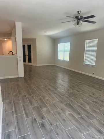 wooden floor in an empty room with a window