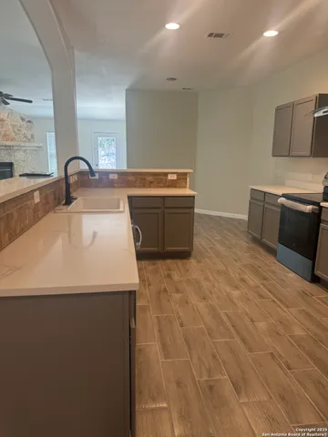 a kitchen with stainless steel appliances a sink and a stove