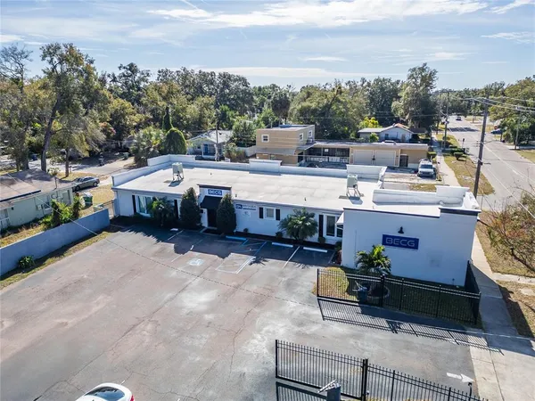 an aerial view of a house with swimming pool and ocean view