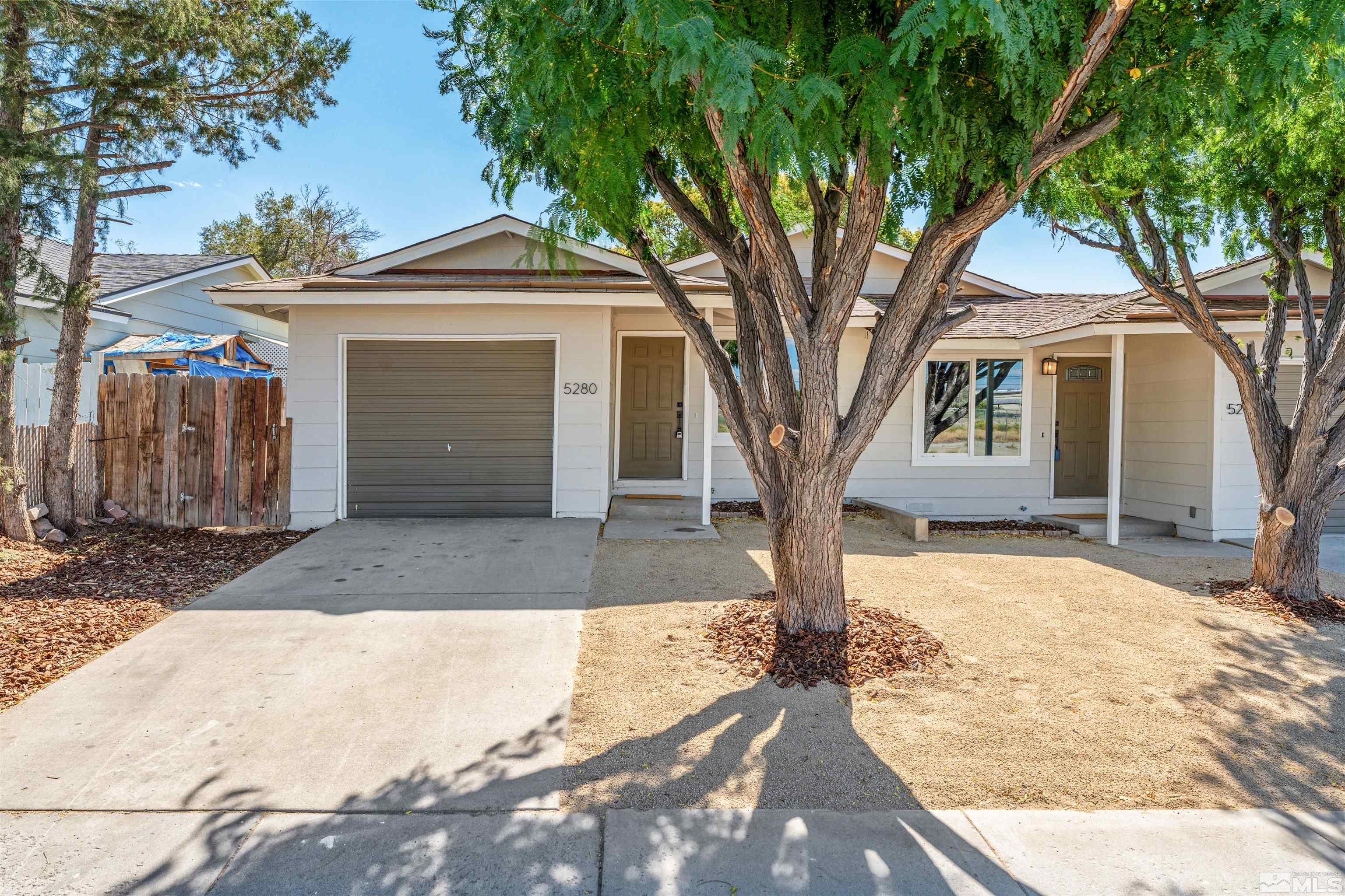 5280 Echo Avenue Reno, NV 89506 - Photo 1 of 31 a front view of a house with a yard