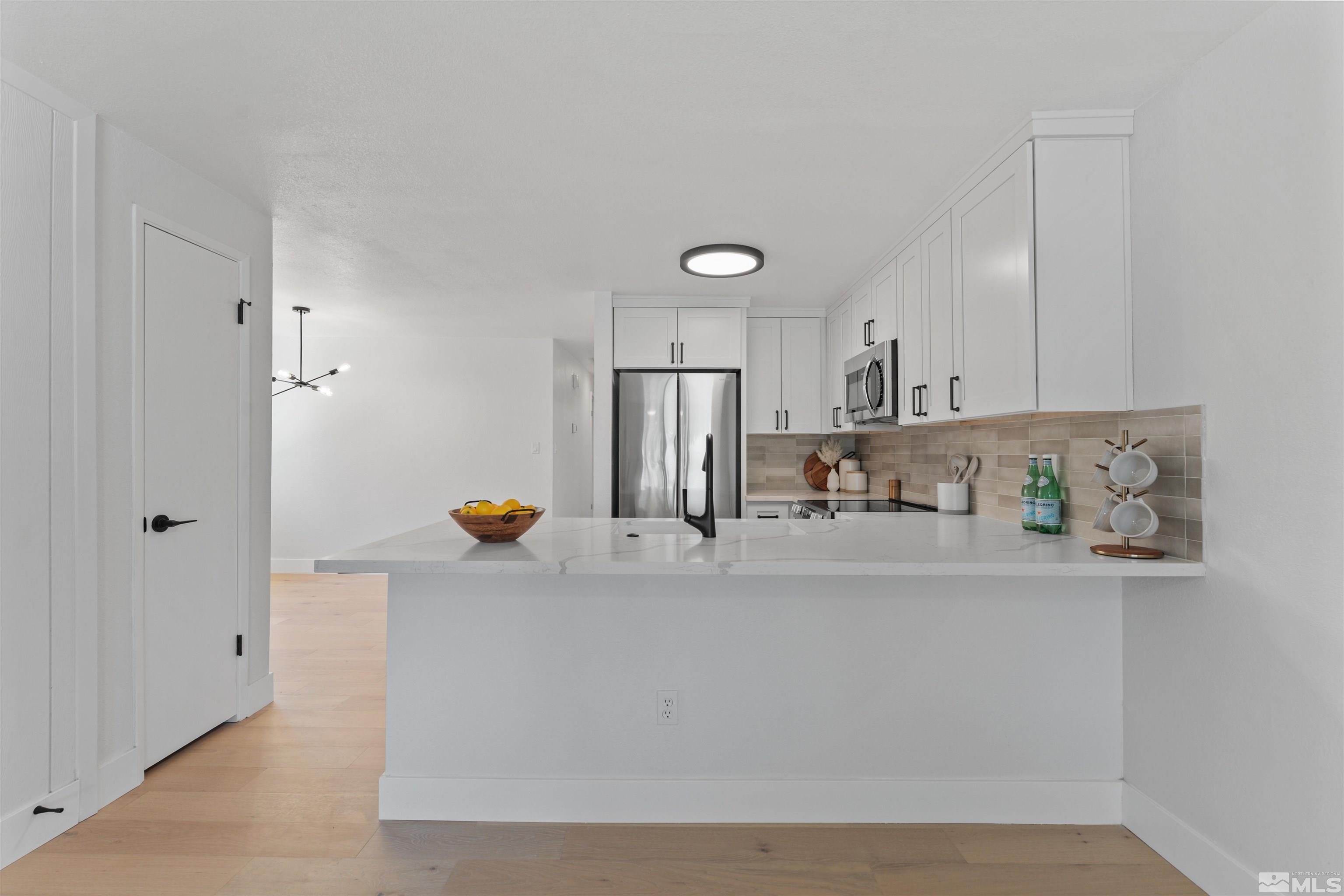 5280 Echo Avenue Reno, NV 89506 - Photo 6 of 31 a view of kitchen island with stainless steel appliances granite countertop refrigerator and a sink