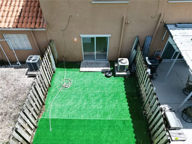 an aerial view of a house with outdoor space pool seating area and yard