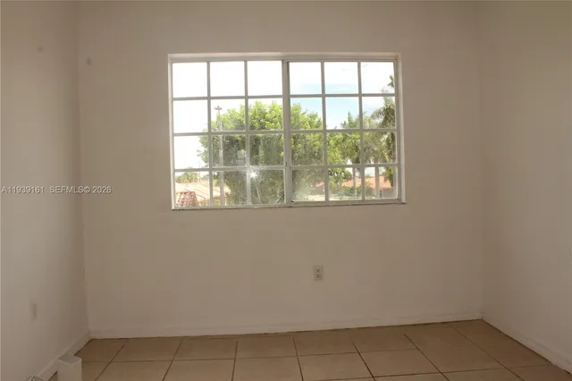 a view of a yard with wooden fence