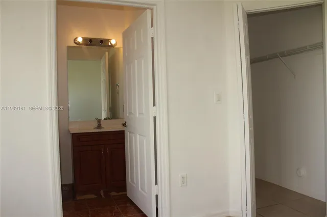 a bathroom with a sink and mirror