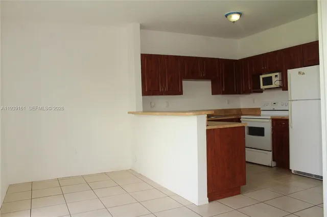 a kitchen with a sink a stove and cabinets
