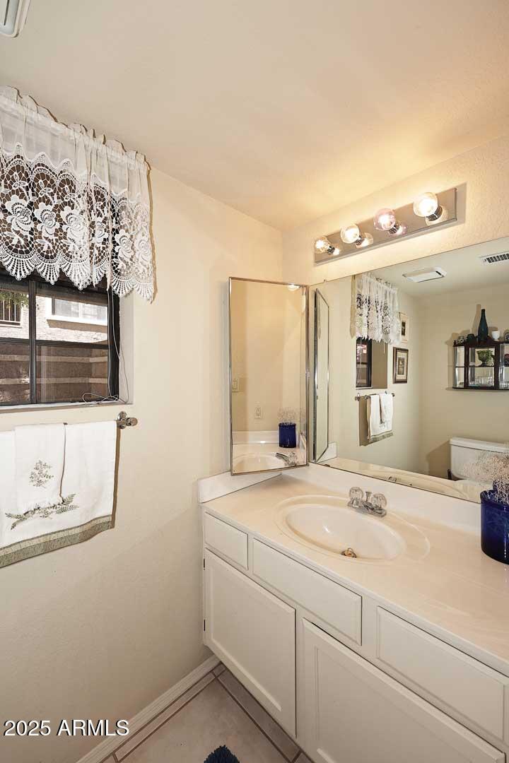 6945 East Cochise Road, Unit 117 Paradise Valley, AZ 85253 - Photo 11 of 39 a bathroom with a sink and a mirror