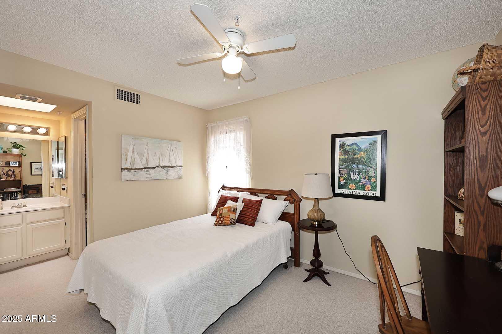 6945 East Cochise Road, Unit 117 Paradise Valley, AZ 85253 - Photo 12 of 39 a bedroom with a bed and a chandelier