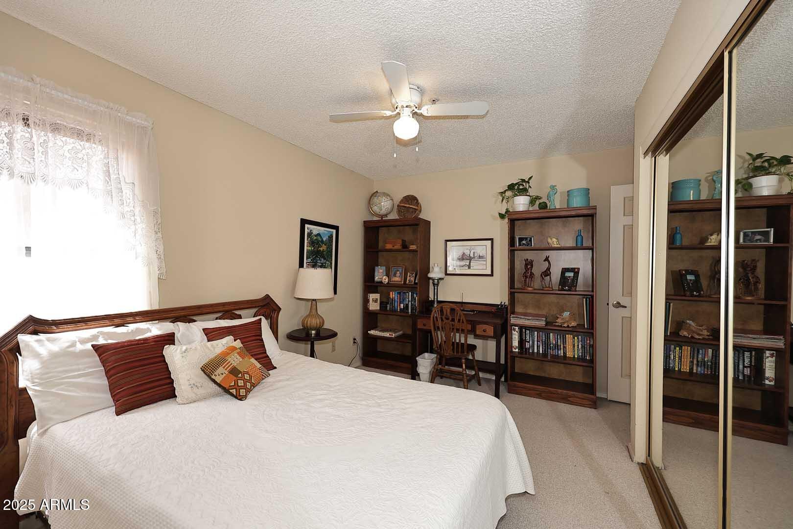 6945 East Cochise Road, Unit 117 Paradise Valley, AZ 85253 - Photo 13 of 39 a bedroom with a bed and a chandelier