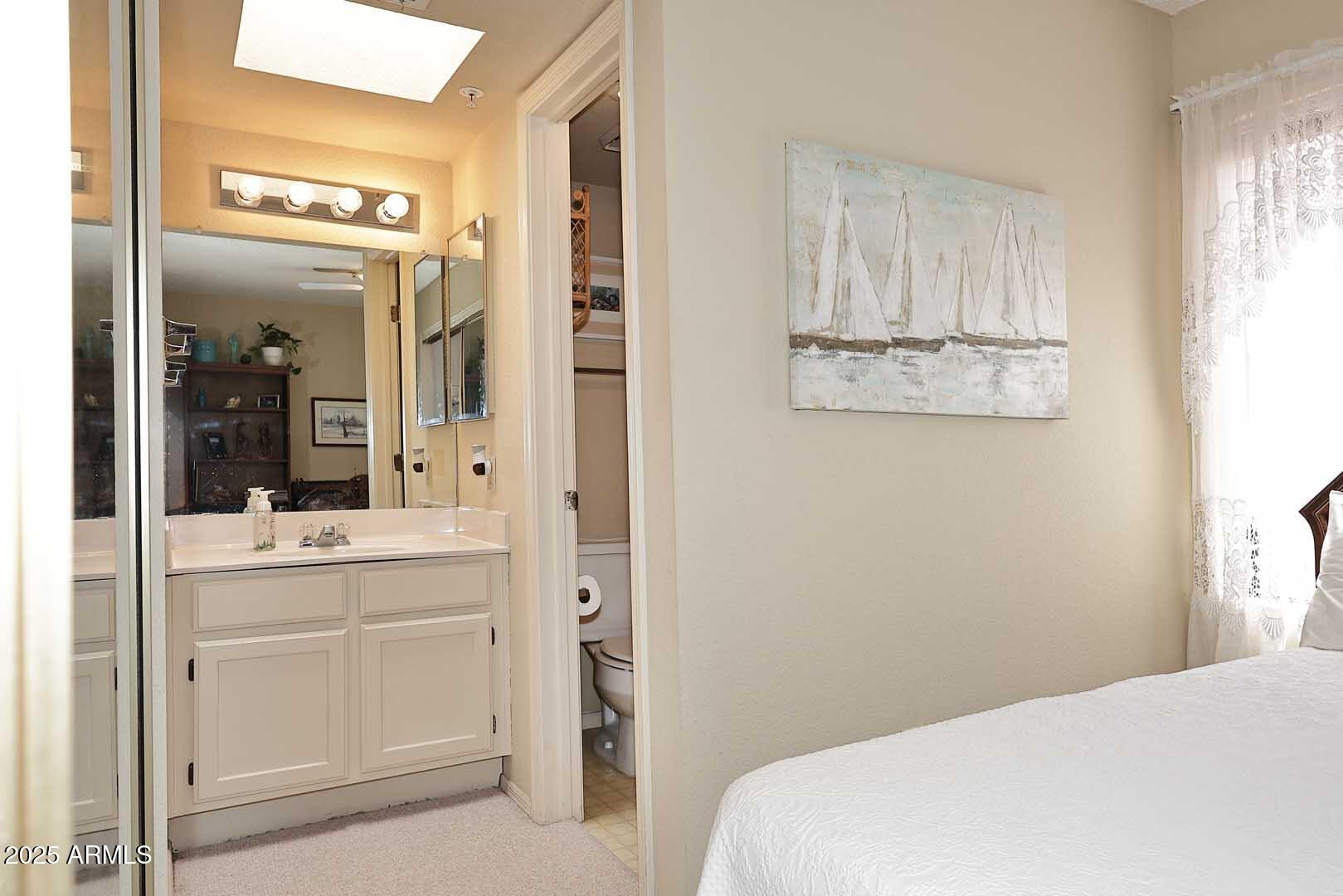 6945 East Cochise Road, Unit 117 Paradise Valley, AZ 85253 - Photo 14 of 39 a bathroom with a sink a mirror and shower