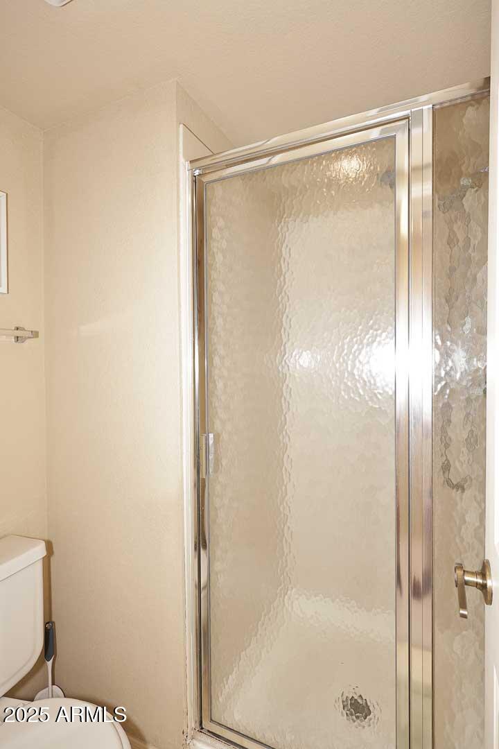 6945 East Cochise Road, Unit 117 Paradise Valley, AZ 85253 - Photo 15 of 39 a bathroom with a glass shower door