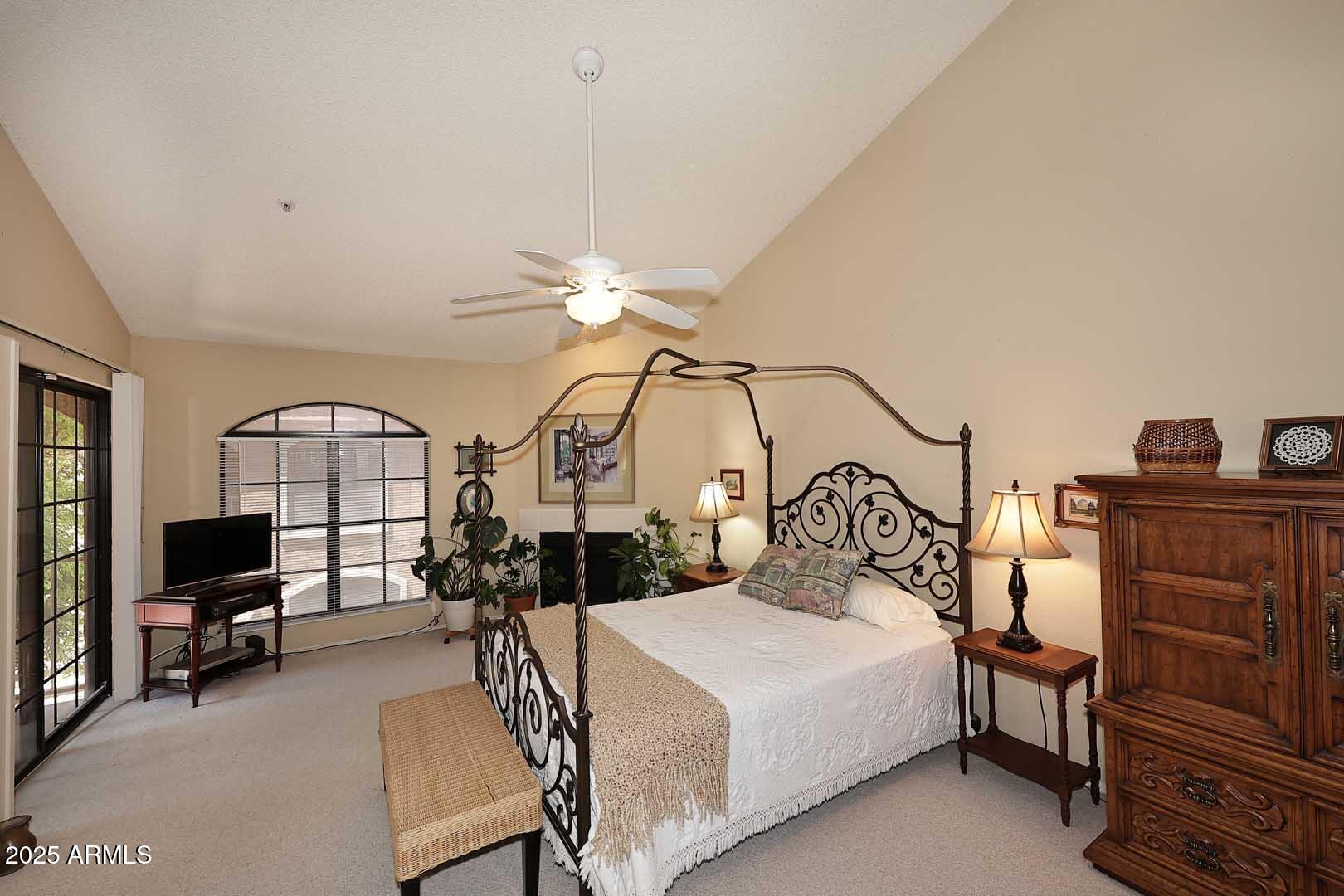 6945 East Cochise Road, Unit 117 Paradise Valley, AZ 85253 - Photo 16 of 39 a bedroom with furniture and a chandelier