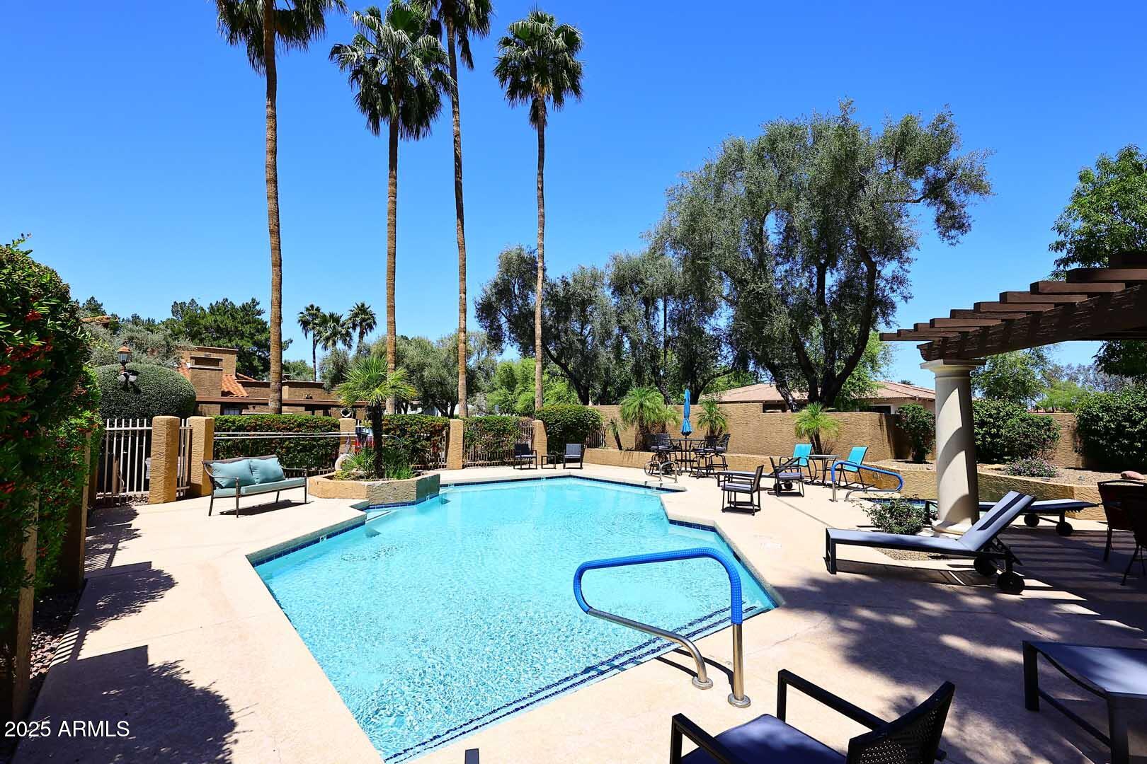 6945 East Cochise Road, Unit 117 Paradise Valley, AZ 85253 - Photo 28 of 39 a view of a swimming pool with chairs