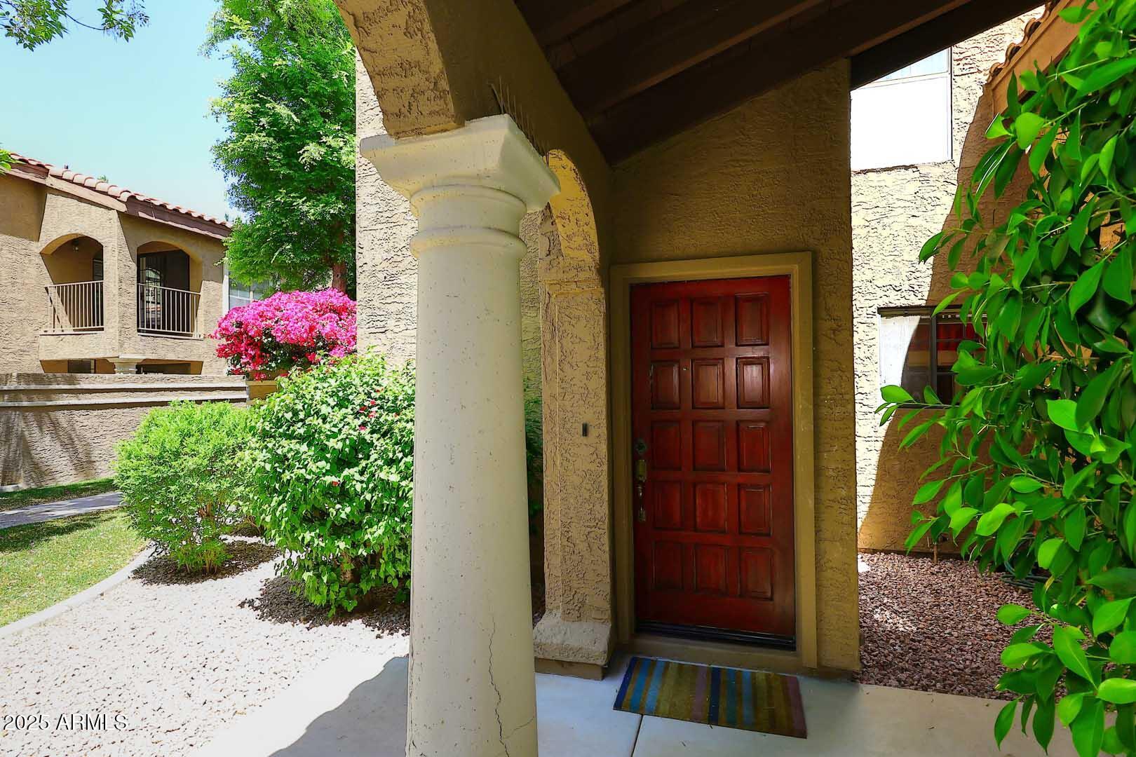 6945 East Cochise Road, Unit 117 Paradise Valley, AZ 85253 - Photo 2 of 39 a front view of a house with a yard