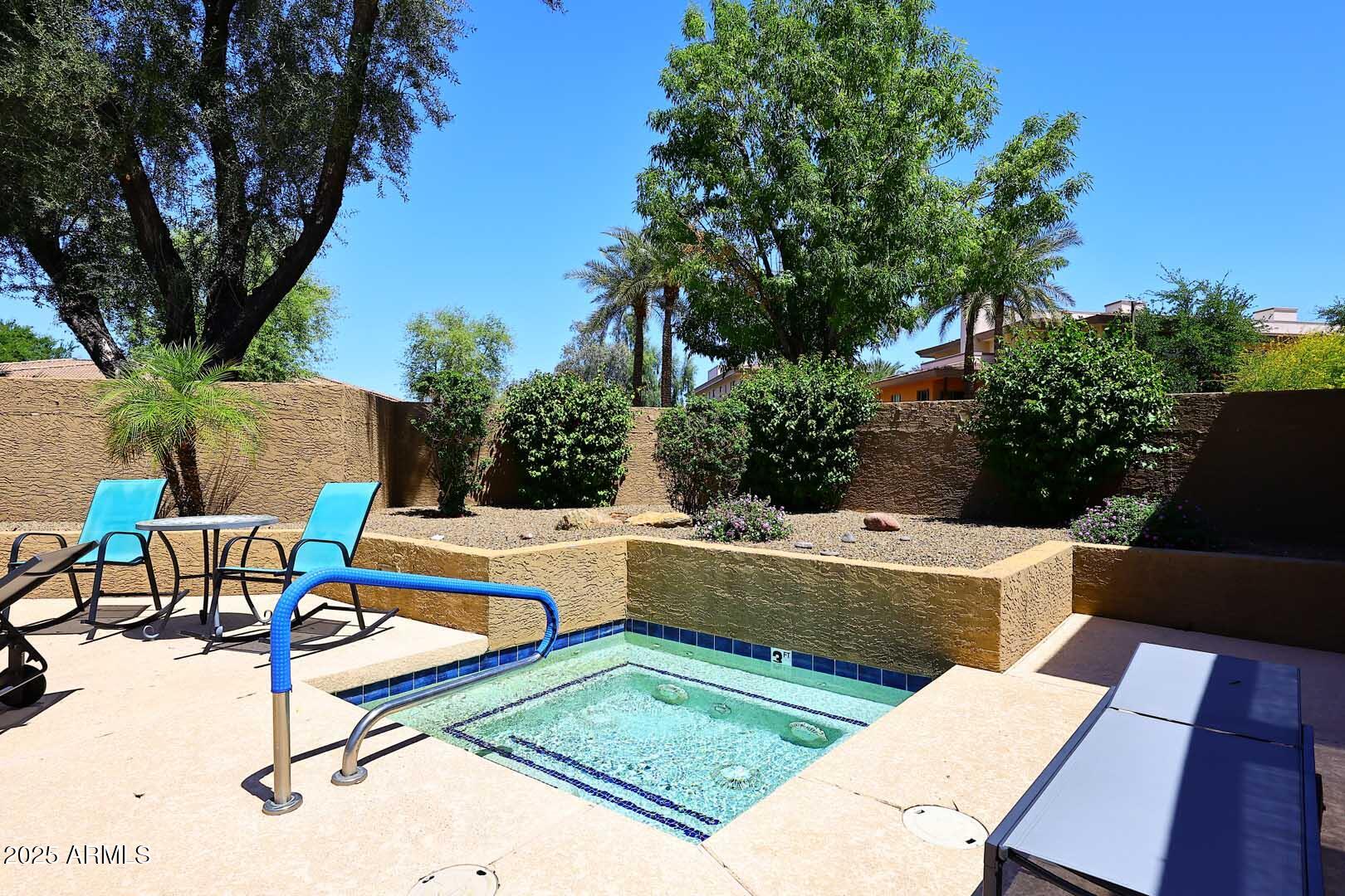 6945 East Cochise Road, Unit 117 Paradise Valley, AZ 85253 - Photo 29 of 39 a view of backyard with swimming pool and sitting area