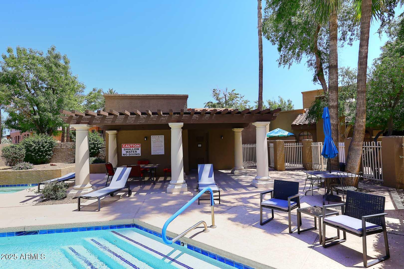 6945 East Cochise Road, Unit 117 Paradise Valley, AZ 85253 - Photo 30 of 39 a view of a dinning table and chairs in the patio
