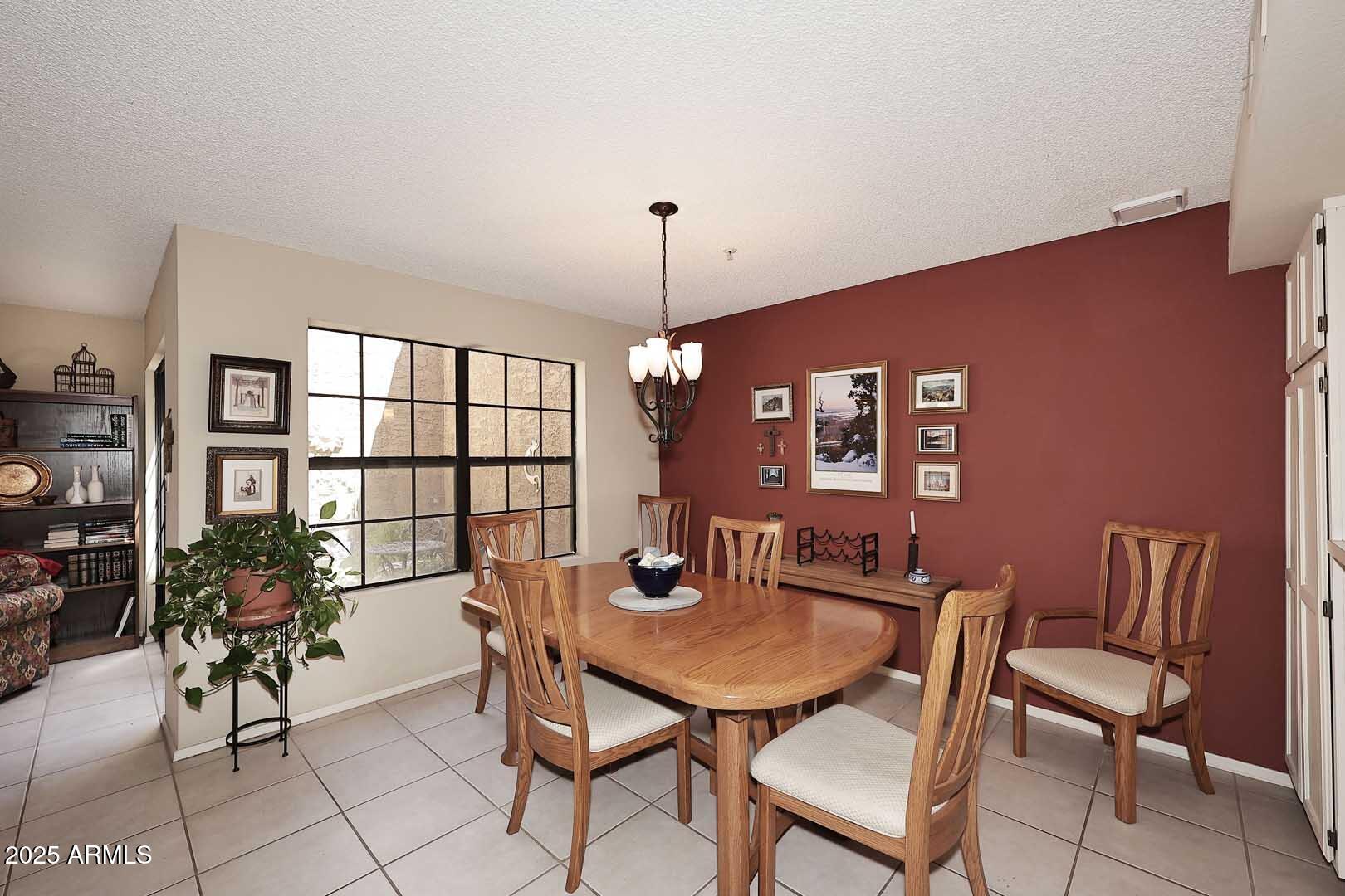 6945 East Cochise Road, Unit 117 Paradise Valley, AZ 85253 - Photo 3 of 39 a view of a dining room with furniture and a window