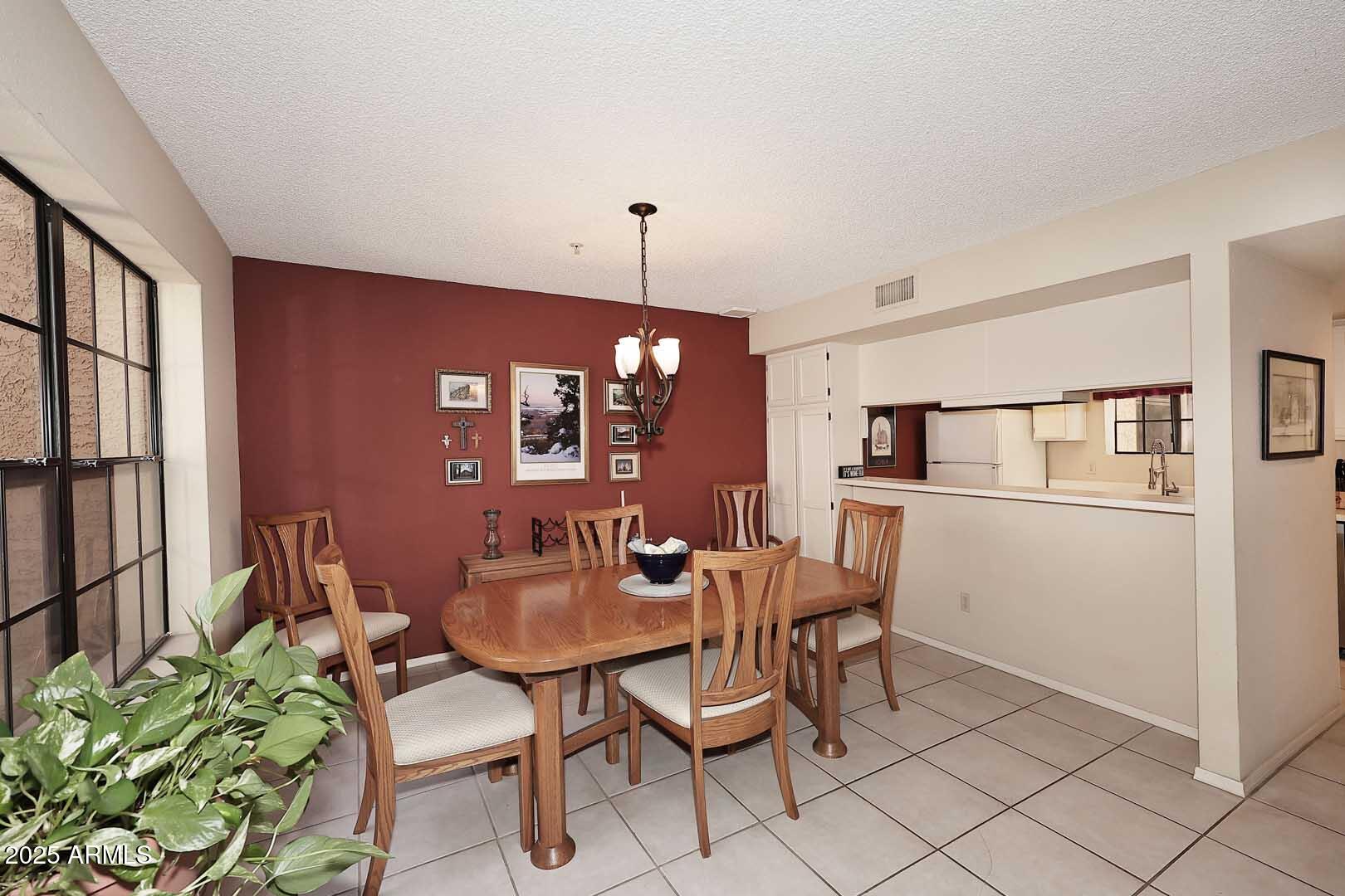 6945 East Cochise Road, Unit 117 Paradise Valley, AZ 85253 - Photo 4 of 39 a dining room with furniture and window