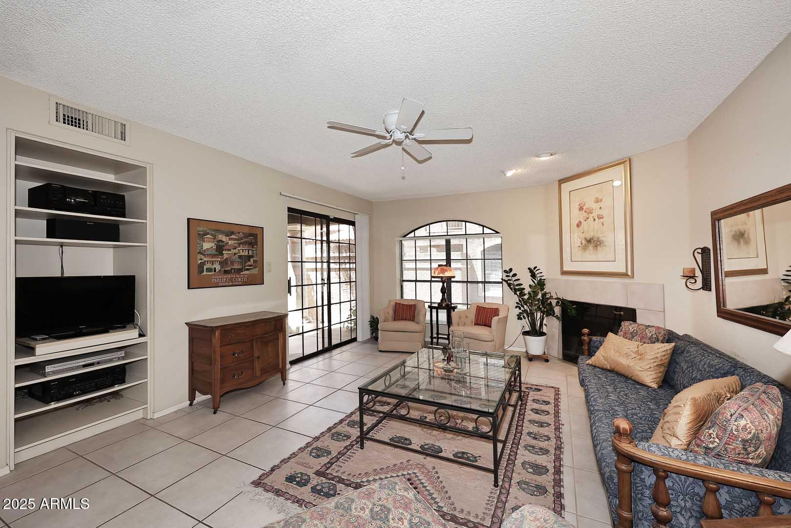 6945 East Cochise Road, Unit 117 Paradise Valley, AZ 85253 - Photo 8 of 39 a living room with furniture a flat screen tv and a window