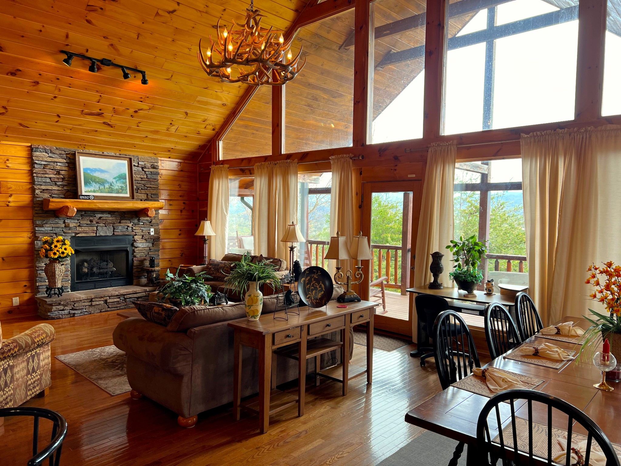 1724 Bluff Ridge Road Sevierville, TN 37876 - Photo 12 of 29 a living room with furniture a fireplace and floor to ceiling windows