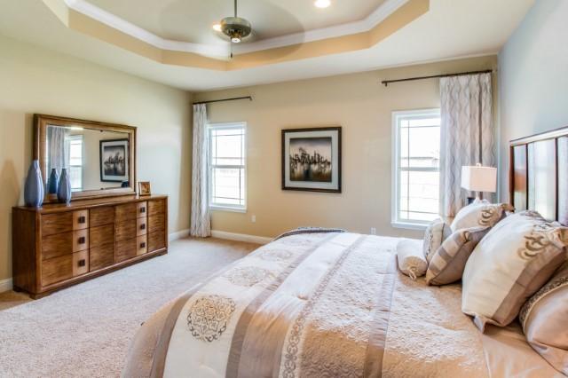 303 Merlin Court Crestview, FL 32539 - Photo 10 of 18 a bedroom with a large bed and a dresser