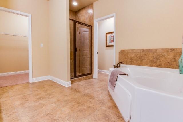 303 Merlin Court Crestview, FL 32539 - Photo 11 of 18 a bathroom with a bathtub and a shower