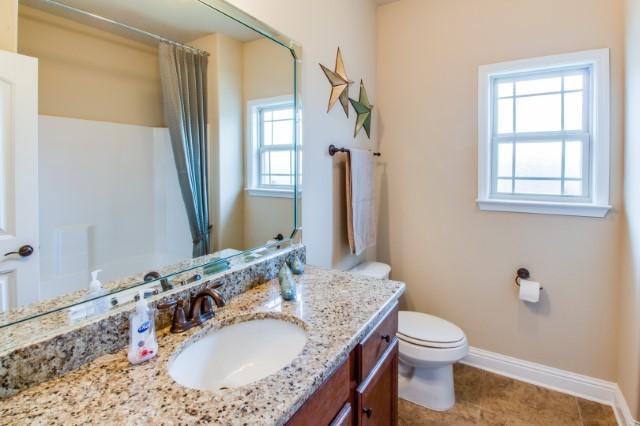 303 Merlin Court Crestview, FL 32539 - Photo 2 of 18 a bathroom with a granite countertop sink toilet and shower
