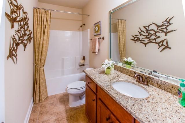 303 Merlin Court Crestview, FL 32539 - Photo 3 of 18 a bathroom with a granite countertop sink a toilet and a mirror