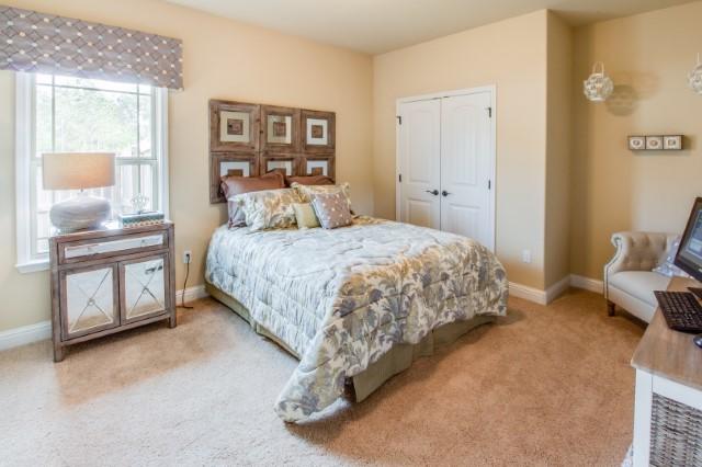 303 Merlin Court Crestview, FL 32539 - Photo 4 of 18 a bedroom with a bed and a chair