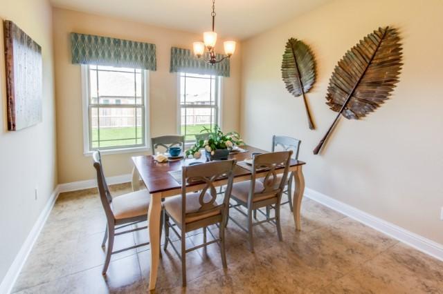 303 Merlin Court Crestview, FL 32539 - Photo 7 of 18 a dining room with furniture a chandelier and wooden floor