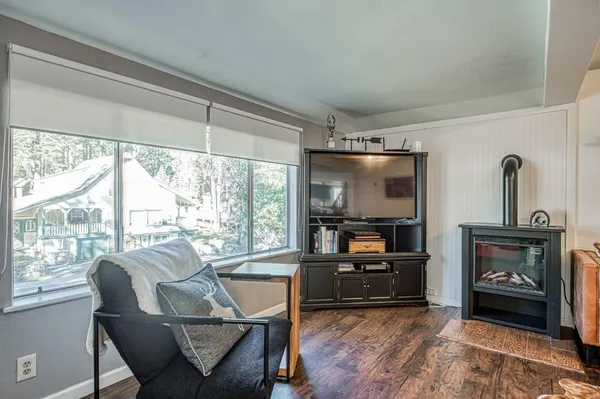 a view of a livingroom with furniture and hardwood floor
