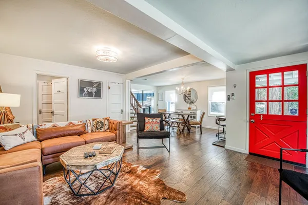 a view of a dining room with furniture and a chandelier