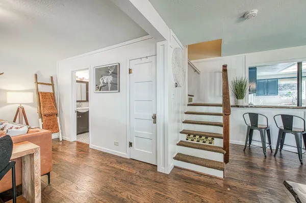 a large bathroom with a granite countertop sink a mirror and a bathtub