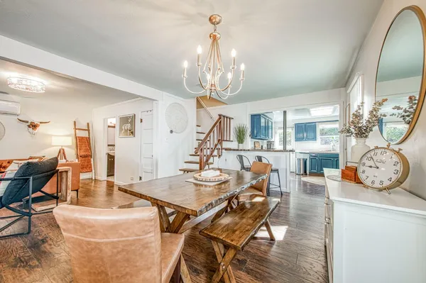 a kitchen with stainless steel appliances granite countertop a sink and cabinets with wooden floor