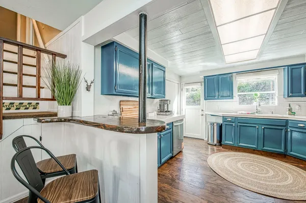a kitchen with stainless steel appliances granite countertop cabinets sink and window