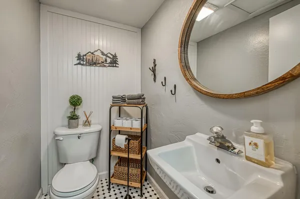 a bedroom with a bed and a mirror