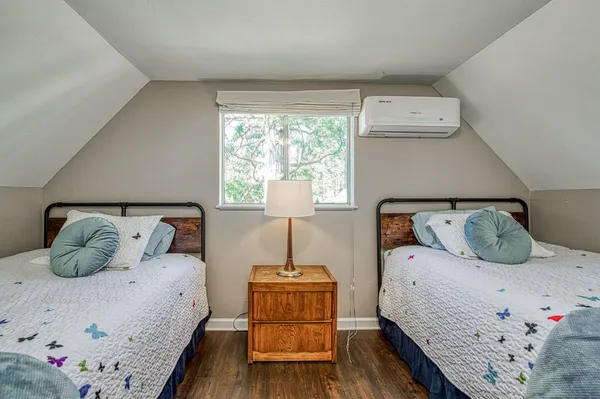 a pathway of a house with yard and sitting area