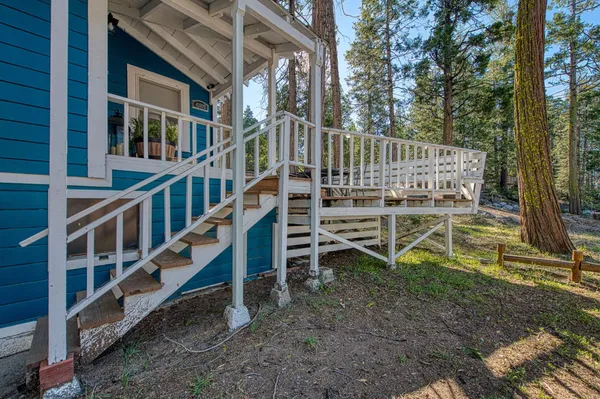 a view of a patio with table and chairs with wooden floor and fence