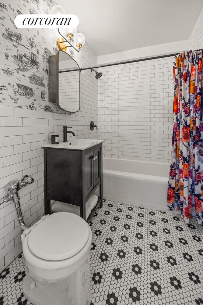 303 Beverley Road, Unit 9K Brooklyn, NY 11218 - Photo 7 of 10 a bathroom with a toilet and a shower