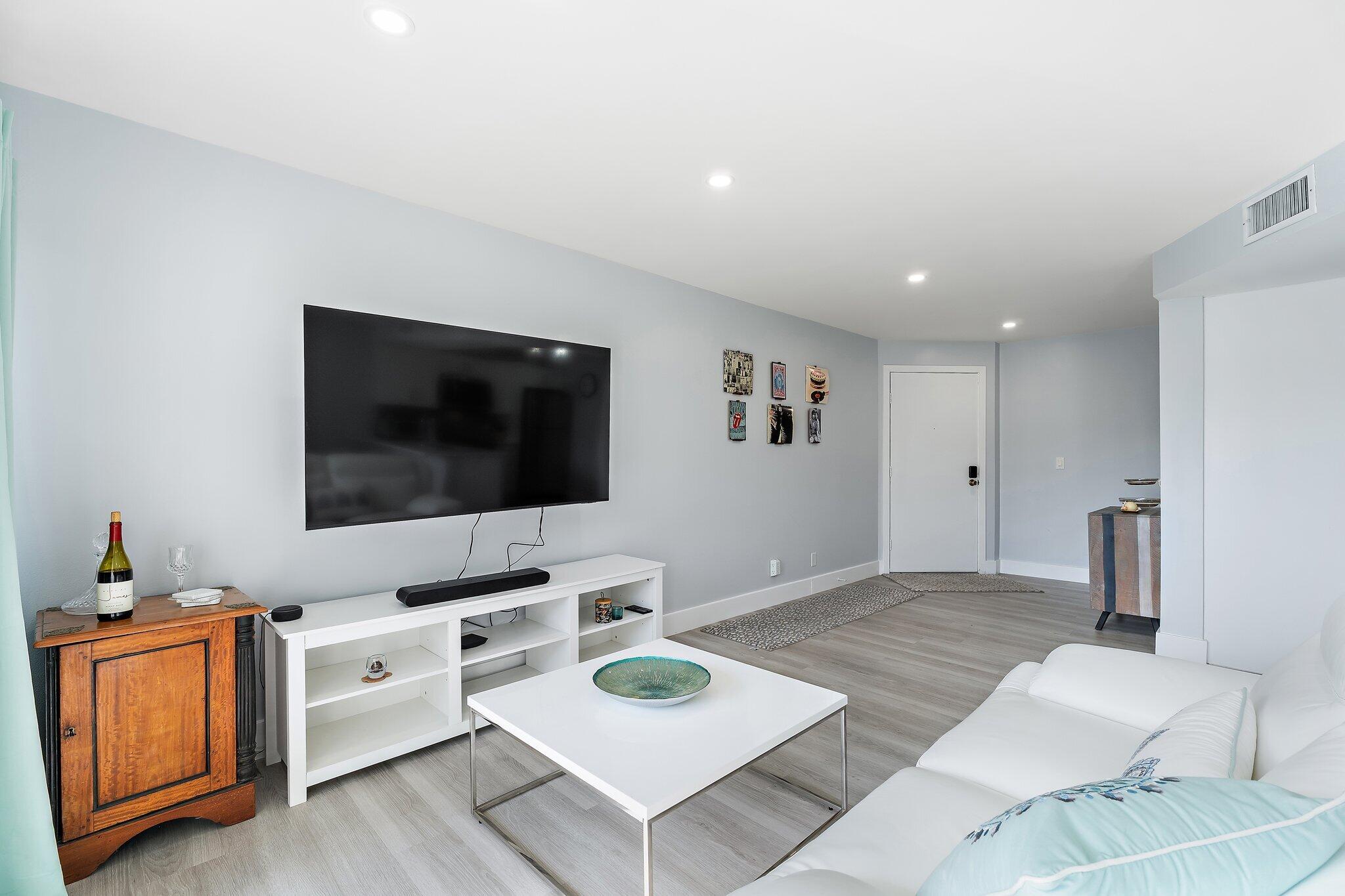 1605 Highway 1, Unit V2204 Jupiter, FL 33477 - Photo 11 of 36 a living room with furniture and a flat screen tv