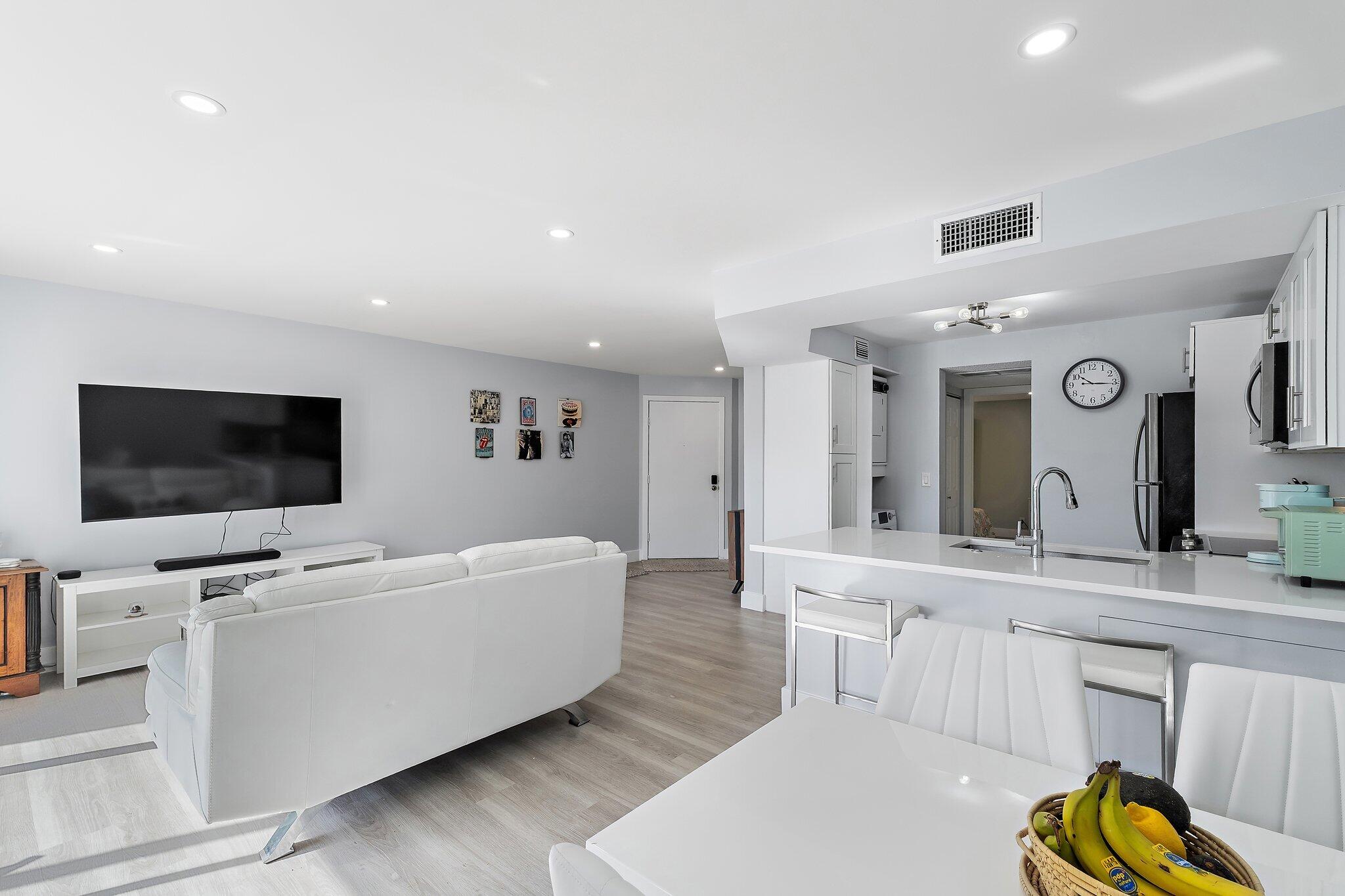 1605 Highway 1, Unit V2204 Jupiter, FL 33477 - Photo 13 of 36 a living room with furniture and a flat screen tv