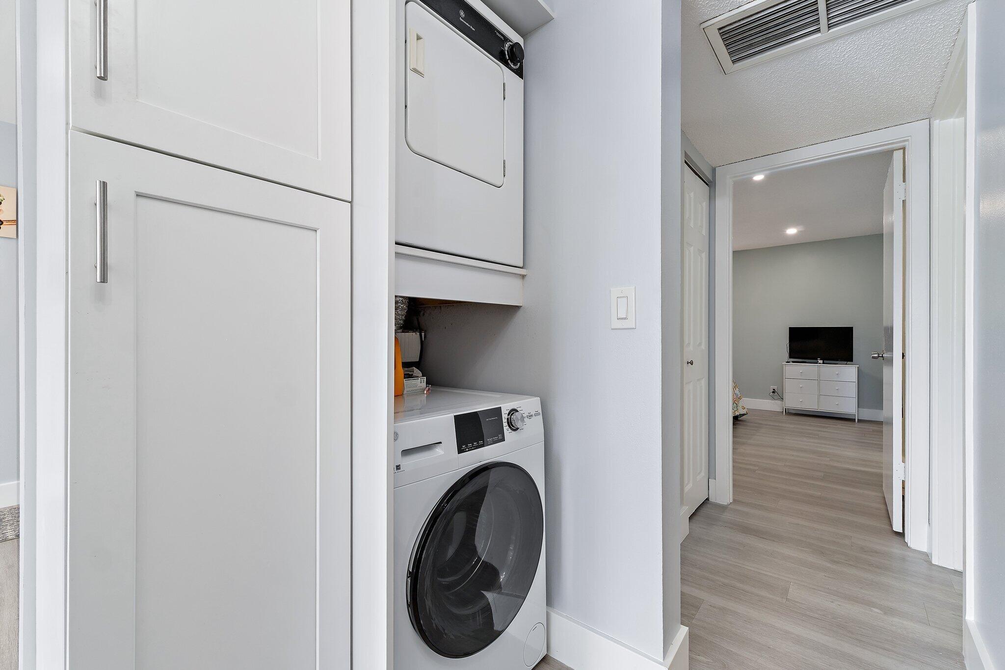 1605 Highway 1, Unit V2204 Jupiter, FL 33477 - Photo 19 of 36 a view of a hallway with washer and dryer