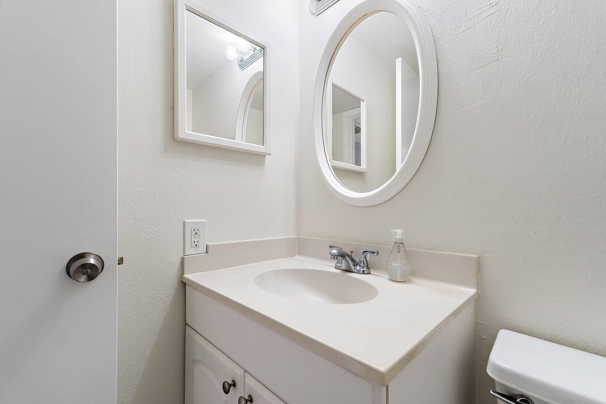 1605 Highway 1, Unit V2204 Jupiter, FL 33477 - Photo 20 of 36 a bathroom with 2 sink and a mirror